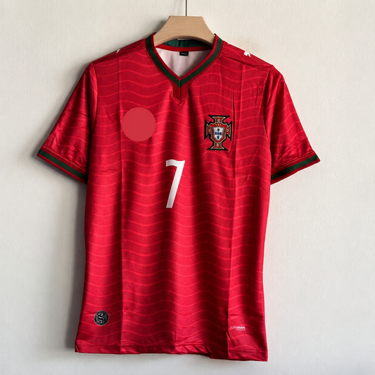 Red sports jersey with a logo and number on a hanger against a light background