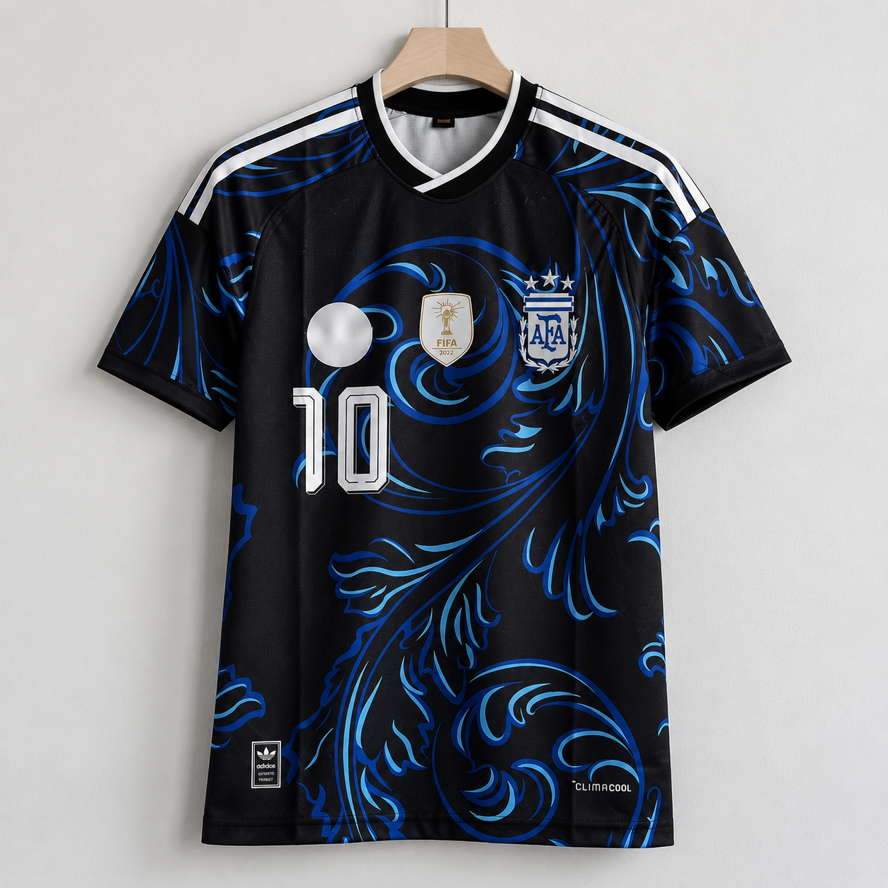 Black sports jersey with blue patterns, number 10, and logos on a hanger against a white background