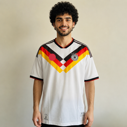 Person wearing a white sports jersey with red, yellow, and black design on a plain background